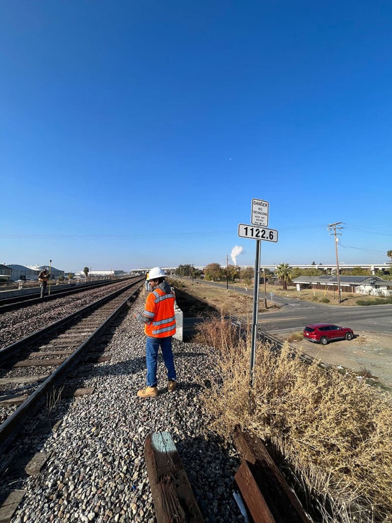 engineer conducting a right-of-way survey at a railroad