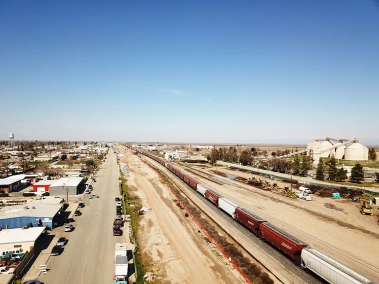 BNSF train operating over the completed shoofly supporting the Poso Ave undercrossing for CA High-Speed Rail