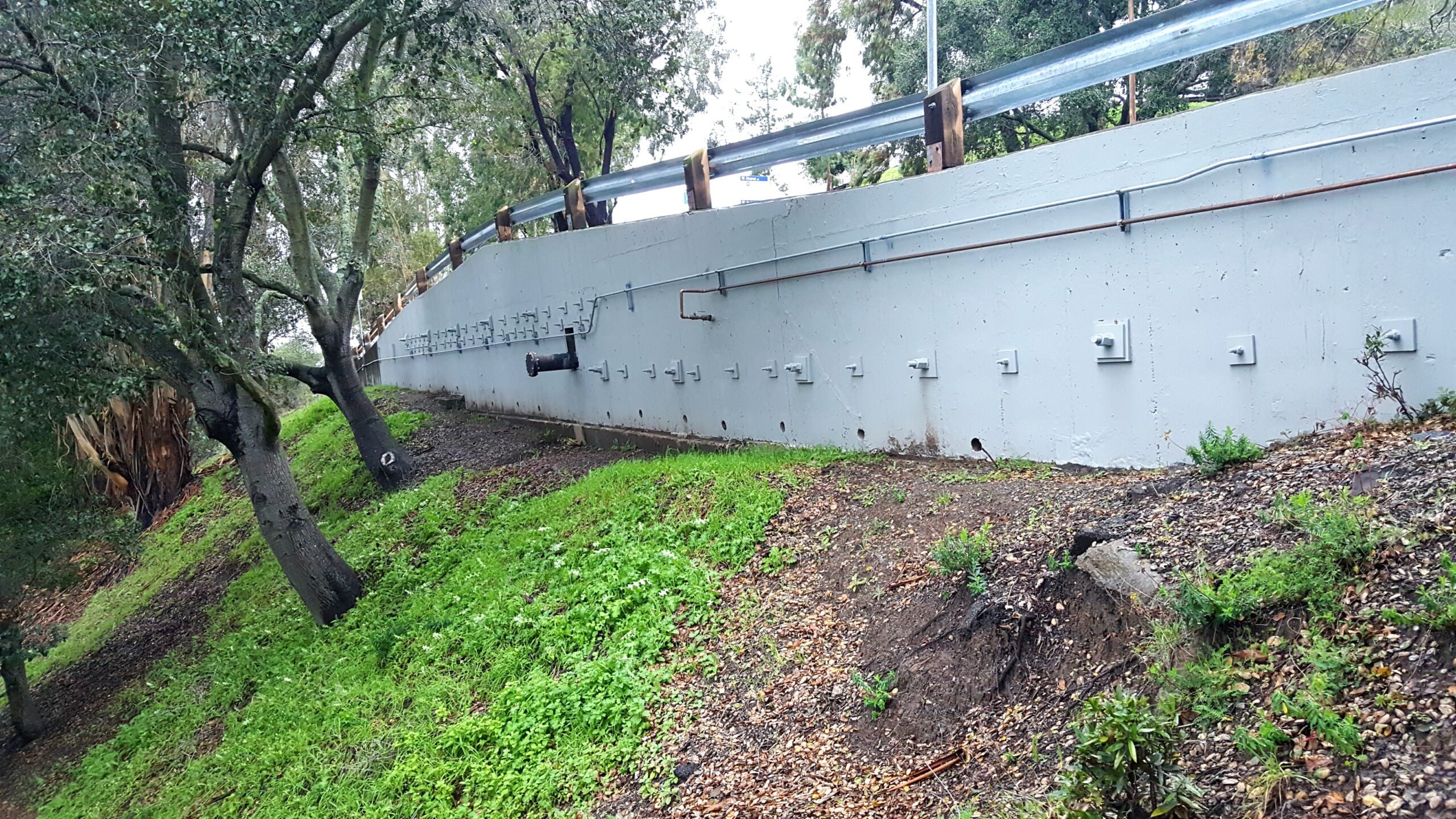 downslope view of a roadway retaining wall