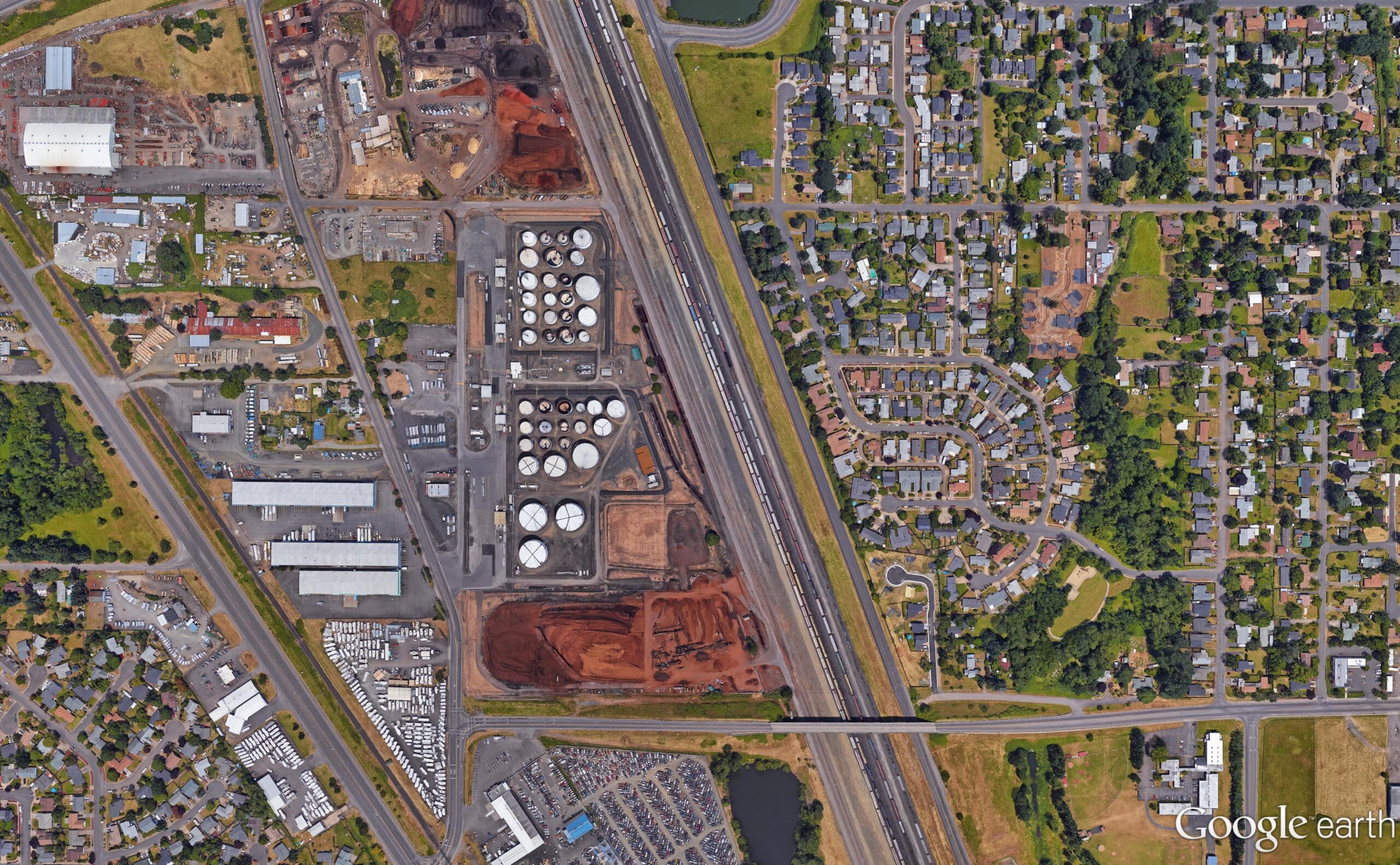 Google earth image showing industry site with tracks running alongside it