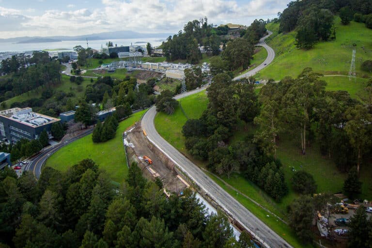 road travels along tree covered hillside